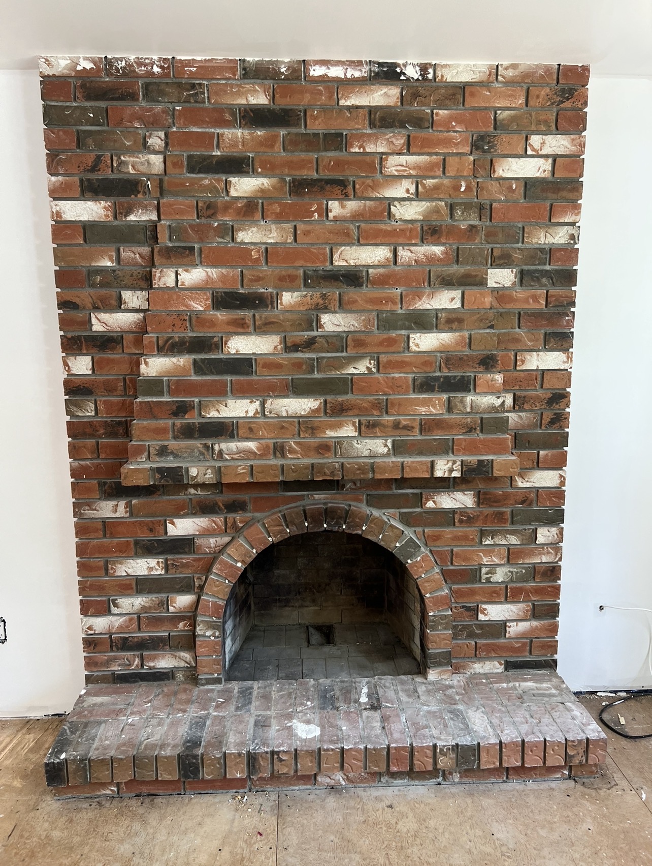 Before view of dated brick fireplace in Brookswood, Langley